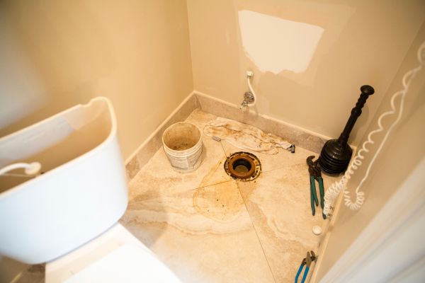 A toilet that has been leaking is being replaced